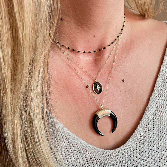 Black oval star gold