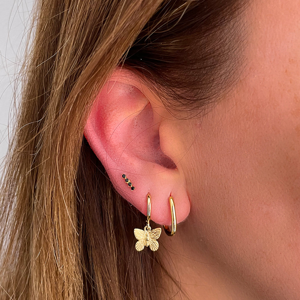 Black line piercing gold