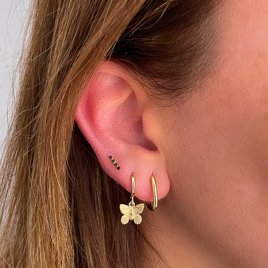 Black line piercing gold